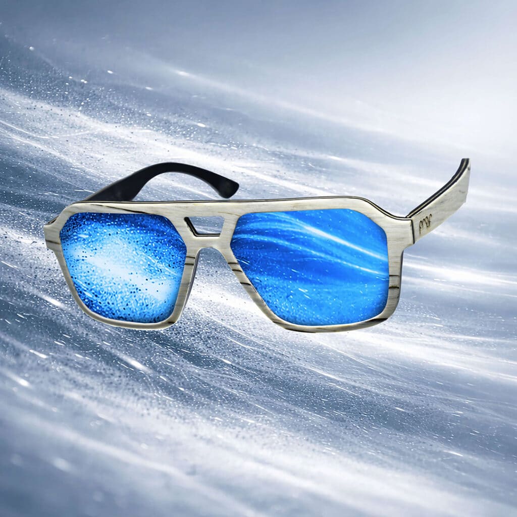 EskerWood-WhiteZebraWood-IceBlueLens Wooden sunglasses with blue mirrored lenses set against streaking snow drifts.