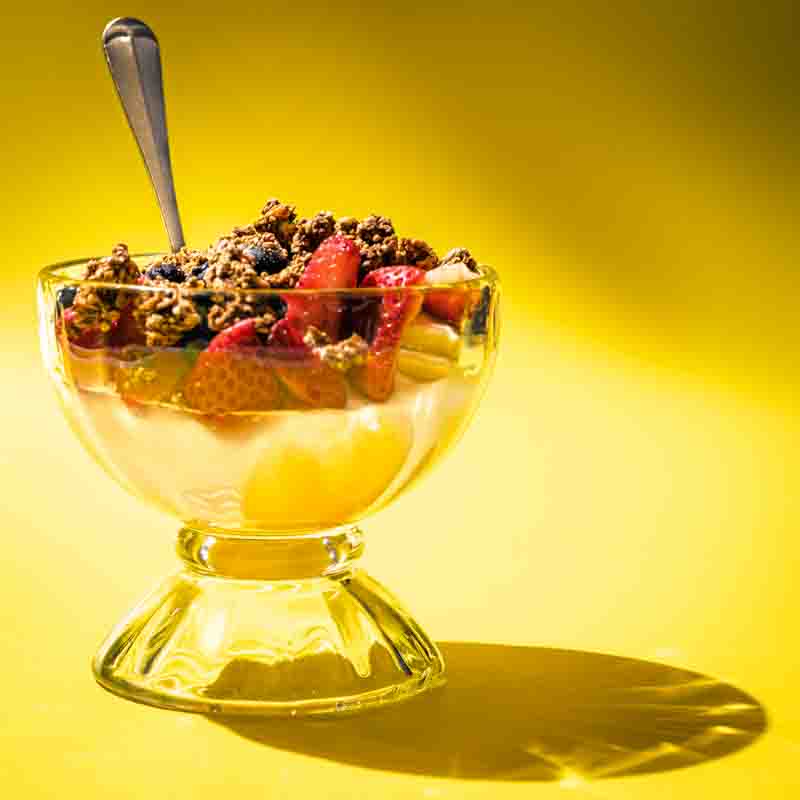 restaurant-branding-daytrip-diner-rich-noah-creative a glass goblet filled with porridge and topped with granola and fresh berries.