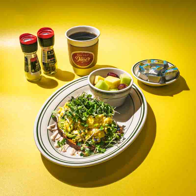 restaurant-food-daytrip-diner-grapevine-texas scrambled eggs with a cup of fruit on a plate served with a cup of coffee